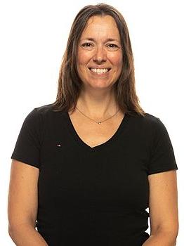 Headshot photo of Vania Schimpf standing in front of a white background.